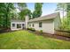 Rear exterior of home featuring fenced yard, sodded lawn, and covered patio at 2109 Tranquility Ct, Woodstock, GA 30188