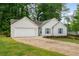 Charming single-story home with a white exterior, attached garage, and well-maintained lawn and landscaping at 2109 Tranquility Ct, Woodstock, GA 30188