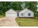 Charming single-story home with white siding, blue shutters, and well-manicured lawn at 2109 Tranquility Ct, Woodstock, GA 30188