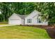 Well-kept one-story home featuring a green lawn, garage, and fresh landscaping at 2109 Tranquility Ct, Woodstock, GA 30188