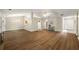 Open-concept living area with hardwood floors, view of the kitchen, and ample natural light at 2109 Tranquility Ct, Woodstock, GA 30188