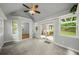 Cozy sunroom with a ceiling fan, backyard access, and bright windows for natural light at 2109 Tranquility Ct, Woodstock, GA 30188