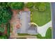 Aerial shot of the home, highlighting the spacious yard, driveway, and mature trees at 3550 Miller Farms Ln, Peachtree Corners, GA 30096