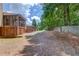 Spacious backyard with mature trees, lush greenery, and a screened-in porch at 3550 Miller Farms Ln, Peachtree Corners, GA 30096