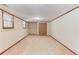 Spacious basement area featuring neutral carpet, paneled doors, and natural light from two windows at 3550 Miller Farms Ln, Peachtree Corners, GA 30096