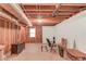 Unfinished basement with exposed ceiling, wooden support beams, and vintage furniture at 3550 Miller Farms Ln, Peachtree Corners, GA 30096