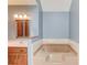 Bathroom with a soaking tub, vanity, and neutral tones at 3550 Miller Farms Ln, Peachtree Corners, GA 30096