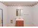 Powder room featuring a vanity with a sink, a mirror, and floral wallpaper at 3550 Miller Farms Ln, Peachtree Corners, GA 30096