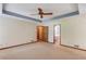 The bedroom features neutral walls, plush carpeting, and a ceiling fan for added comfort at 3550 Miller Farms Ln, Peachtree Corners, GA 30096