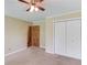 Bedroom with carpet, ceiling fan, double closet doors, and neutral paint at 3550 Miller Farms Ln, Peachtree Corners, GA 30096