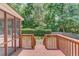 Wooden deck with steps leading to a lush green backyard and mature trees at 3550 Miller Farms Ln, Peachtree Corners, GA 30096