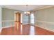 Elegant dining room with hardwood floors, wainscoting, a chandelier, and natural light at 3550 Miller Farms Ln, Peachtree Corners, GA 30096