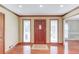 Inviting foyer with hardwood floors, wood trim, recessed lighting, and a front door with sidelights at 3550 Miller Farms Ln, Peachtree Corners, GA 30096