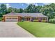 Charming single-story brick home with a well-manicured lawn and colorful landscaping, plus a 2 car garage at 3550 Miller Farms Ln, Peachtree Corners, GA 30096