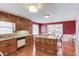 Well-lit kitchen with an island, wooden cabinets, and stainless steel appliances at 3550 Miller Farms Ln, Peachtree Corners, GA 30096