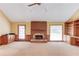 Spacious living room featuring a brick fireplace, built-in cabinets, and a wet bar at 3550 Miller Farms Ln, Peachtree Corners, GA 30096