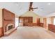 Inviting living room featuring a brick fireplace, vaulted ceiling, and built-in shelving at 3550 Miller Farms Ln, Peachtree Corners, GA 30096