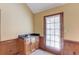 A charming wet bar area with sink, cabinets, and natural light from the backyard access door at 3550 Miller Farms Ln, Peachtree Corners, GA 30096