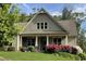 Inviting home featuring a covered porch, tidy landscaping, and flowering shrubs at 37 Grand Georgian Ne Ct, Cartersville, GA 30121