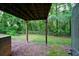 View of the home's backyard featuring green grass and mature trees at 6927 Gallant Se Cir # 11, Mableton, GA 30126