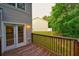Exterior wooden deck with glass door leading to the house, overlooking green backyard and fencing at 6927 Gallant Se Cir # 11, Mableton, GA 30126