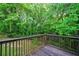 A wooden deck offers views of lush greenery and fenced yard at 6927 Gallant Se Cir # 11, Mableton, GA 30126