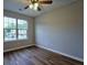 Cozy bedroom with hardwood floors and a large window overlooking the outdoors at 6927 Gallant Se Cir # 11, Mableton, GA 30126
