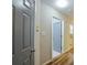 Bright hallway with wood laminate floors, neutral walls, and multiple doorways at 6927 Gallant Se Cir # 11, Mableton, GA 30126