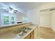 Well-lit kitchen featuring stainless steel sink, neutral countertops, and open layout design at 6927 Gallant Se Cir # 11, Mableton, GA 30126