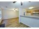 Spacious living area featuring wood floors, a ceiling fan, and a kitchen bar at 6927 Gallant Se Cir # 11, Mableton, GA 30126