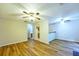 Open-concept living area with wood flooring, ceiling fan, and kitchen bar at 6927 Gallant Se Cir # 11, Mableton, GA 30126