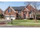 Charming brick home featuring a manicured lawn, attached garage, and complemented by tasteful landscaping at 1107 Carroll Ct, Norcross, GA 30071