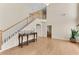 Bright living room features hardwood floors, a staircase, and a large window that lets in natural light at 1107 Carroll Ct, Norcross, GA 30071