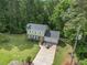 Aerial view showcasing a well-maintained two-story home on a lush, green lot at 2722 Spring Side Ct, Douglasville, GA 30135
