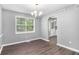 Bright dining room with dark laminate flooring and a modern chandelier at 2722 Spring Side Ct, Douglasville, GA 30135