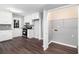 Kitchen featuring white cabinets, stainless steel appliances, wood floors, and access to the laundry room at 2722 Spring Side Ct, Douglasville, GA 30135