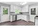 Well-lit kitchen featuring white cabinets, granite countertops, stainless steel appliances, and wood floors at 2722 Spring Side Ct, Douglasville, GA 30135