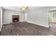 Spacious living room featuring dark laminate flooring and a traditional fireplace at 2722 Spring Side Ct, Douglasville, GA 30135
