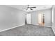 Large primary bedroom with neutral carpet, ceiling fan, and access to the bathroom at 2722 Spring Side Ct, Douglasville, GA 30135