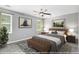 Cozy bedroom with two windows, ceiling fan, and beautifully staged decor and furniture at 2722 Springside Ct, Douglasville, GA 30135