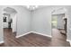 Bright dining room with wood floors features an archway and a modern chandelier at 2722 Springside Ct, Douglasville, GA 30135