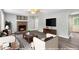 Staged living room with a brick fireplace, gray walls, hardwood floors, and neutral-toned furniture at 2722 Springside Ct, Douglasville, GA 30135