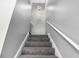Carpeted staircase featuring a modern sphere light fixture and white handrails at 2722 Springside Ct, Douglasville, GA 30135