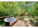 Inviting backyard deck surrounded by mature trees and a cozy outdoor seating area at 4621 Lakeshore Dr, Pine Lake, GA 30072