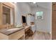 Bathroom featuring a single vanity with a sink, a stained-glass accent window, and neutral paint at 4621 Lakeshore Dr, Pine Lake, GA 30072