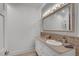 Well-lit bathroom with a large vanity, tile backsplash, and updated fixtures at 4621 Lakeshore Dr, Pine Lake, GA 30072