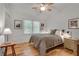 Inviting bedroom featuring hardwood floors, a ceiling fan, and bright natural light at 4621 Lakeshore Dr, Pine Lake, GA 30072
