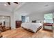 A well lit, spacious main bedroom boasting hardwood floors, a walk in closet, and updated windows at 4621 Lakeshore Dr, Pine Lake, GA 30072