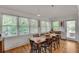 Dining room with hardwood floors, windows with blinds, and view of outdoor area at 4621 Lakeshore Dr, Pine Lake, GA 30072