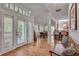 Bright foyer with hardwood floors leading to dining and kitchen areas and private deck at 4621 Lakeshore Dr, Pine Lake, GA 30072